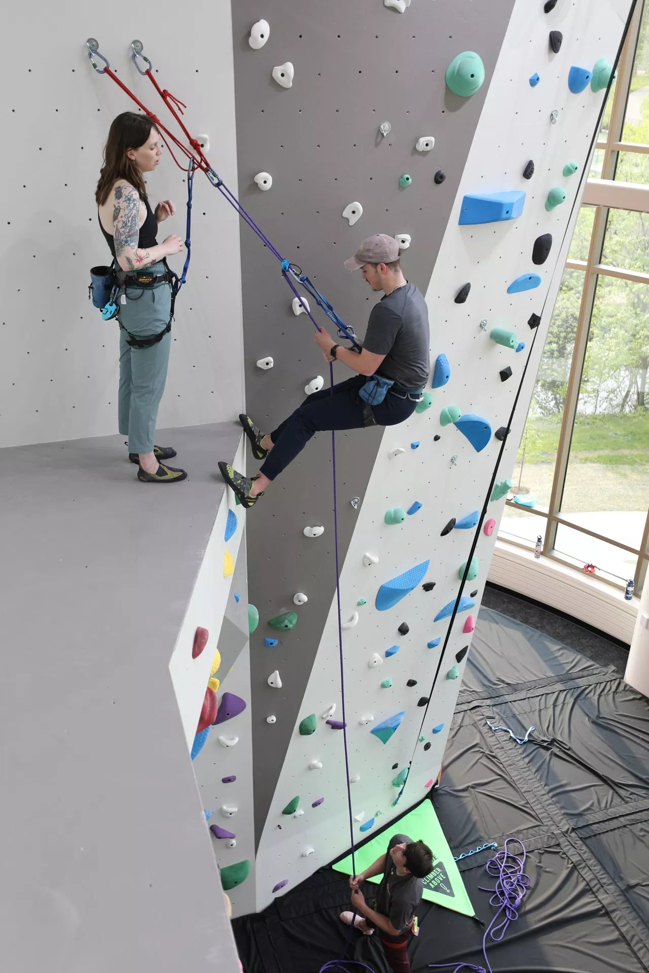 A student climbing an indoor climbing wall installed by Eldorado Walls at the University of Wisconsin-Madison